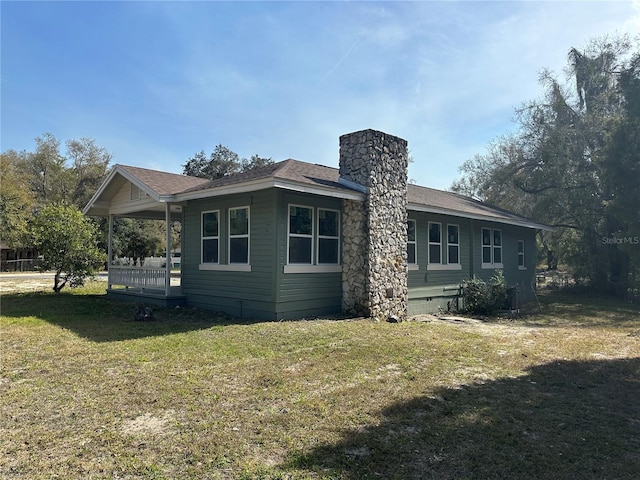 back of house featuring a yard