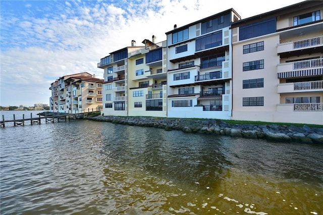 exterior space featuring a balcony and a water view