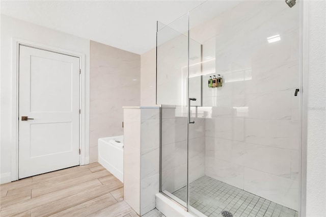 bathroom featuring shower with separate bathtub