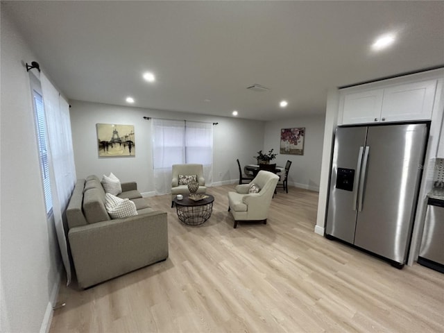 living room with light hardwood / wood-style flooring