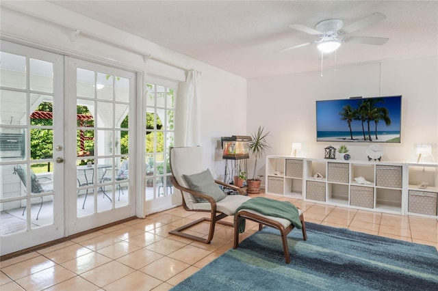 sitting room with ceiling fan, french doors, and light tile patterned floors