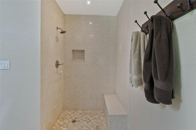 bathroom with a tile shower