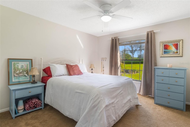 carpeted bedroom with a textured ceiling and ceiling fan