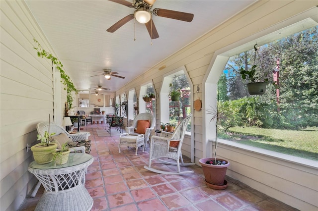 sunroom / solarium with a wealth of natural light and ceiling fan