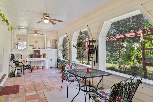 sunroom featuring ceiling fan