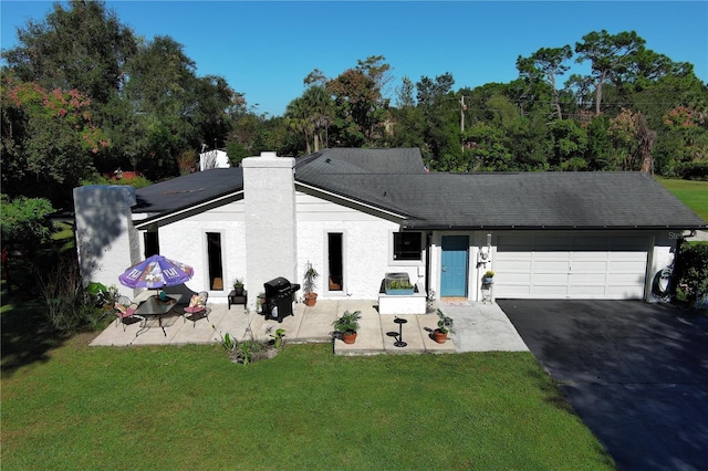 view of front of home with a garage and a front yard