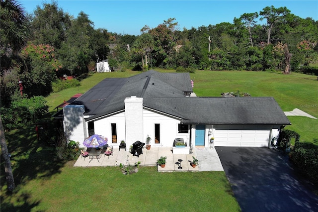 view of front facade with a garage and a front lawn