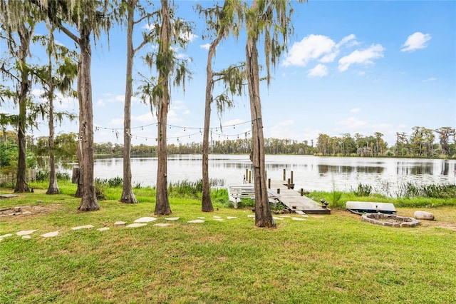 view of yard with a dock and a water view