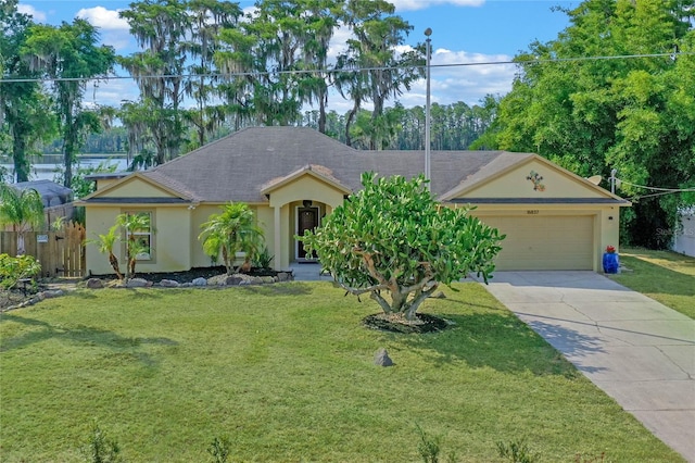 ranch-style home featuring a garage and a front lawn