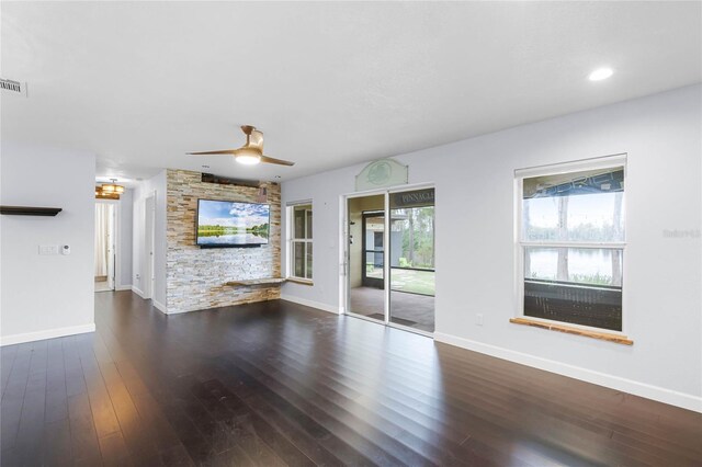 unfurnished living room featuring ceiling fan and dark hardwood / wood-style flooring