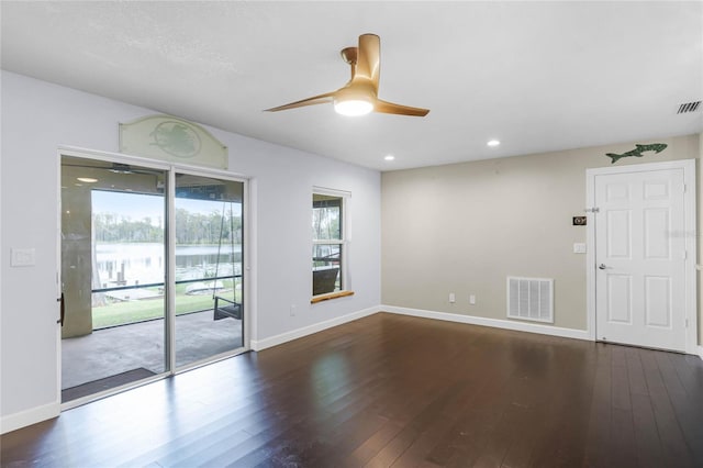 spare room with ceiling fan and dark hardwood / wood-style floors