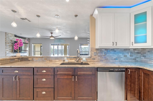 kitchen featuring sink, white cabinetry, stainless steel dishwasher, and hanging light fixtures