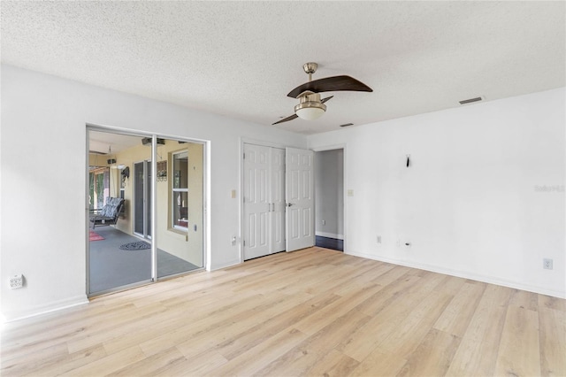 unfurnished bedroom featuring ceiling fan, light hardwood / wood-style floors, and a textured ceiling