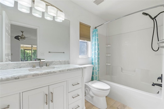 full bathroom with hardwood / wood-style floors, shower / bathtub combination with curtain, vanity, toilet, and ceiling fan