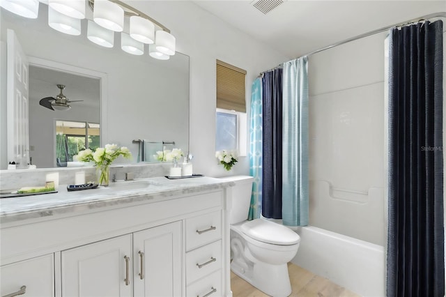 full bathroom featuring hardwood / wood-style flooring, toilet, vanity, and shower / bath combo