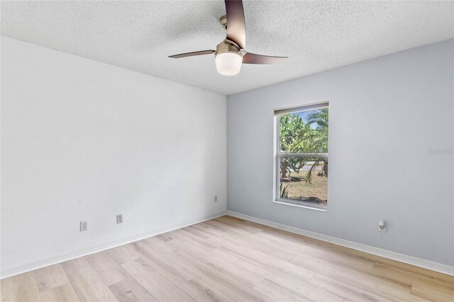 spare room with ceiling fan, light hardwood / wood-style flooring, and a textured ceiling