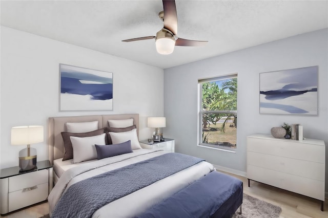 bedroom with ceiling fan and light hardwood / wood-style flooring