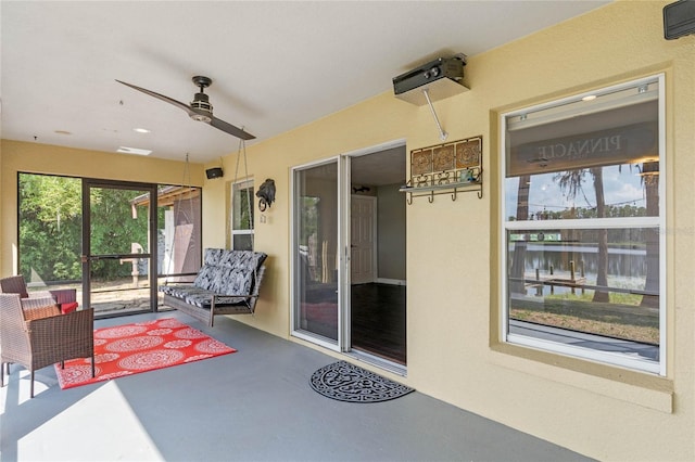 doorway to property featuring ceiling fan