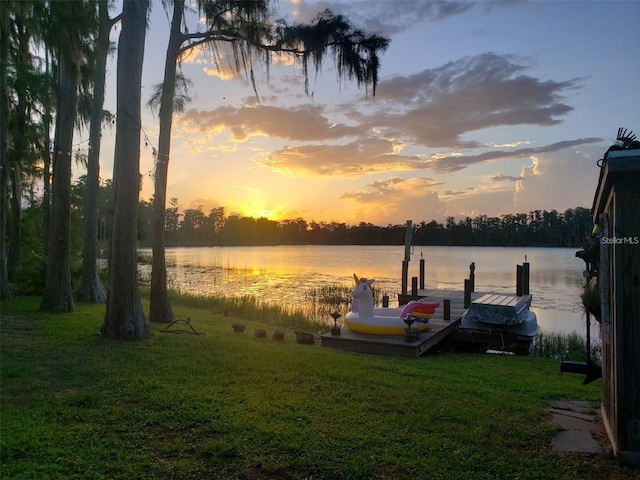 view of dock featuring a yard and a water view