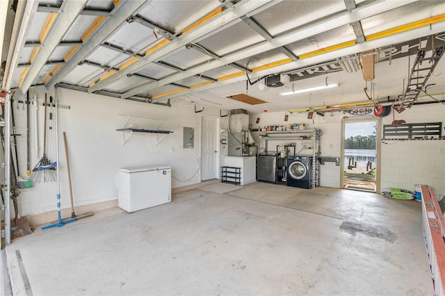 garage with washer and dryer, electric panel, fridge, and a garage door opener