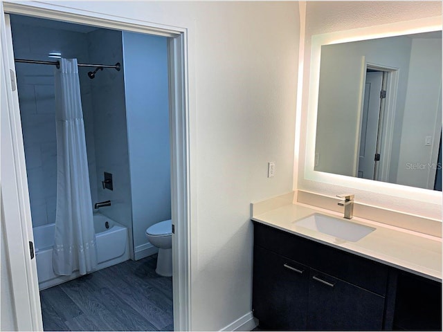 full bathroom featuring vanity, toilet, hardwood / wood-style floors, and shower / bath combo with shower curtain