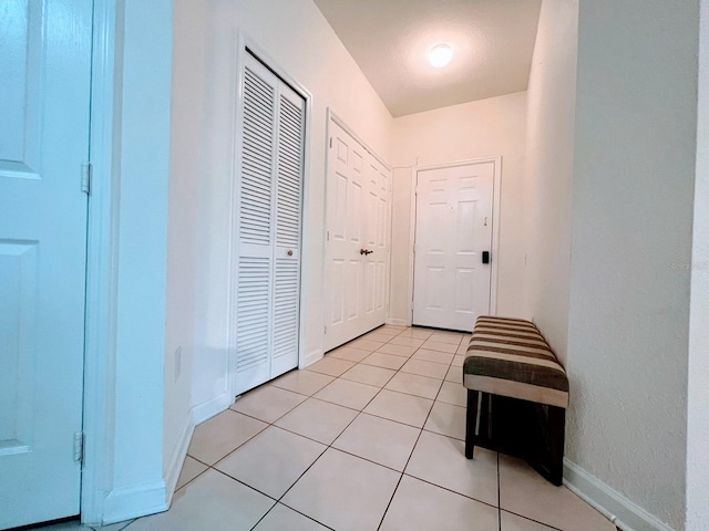 corridor featuring light tile patterned floors