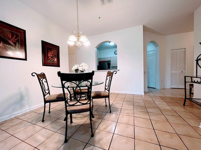 tiled dining space featuring a notable chandelier