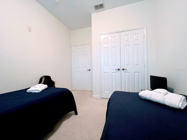 carpeted bedroom with a closet