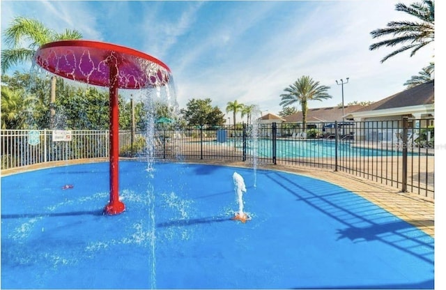 view of swimming pool with pool water feature