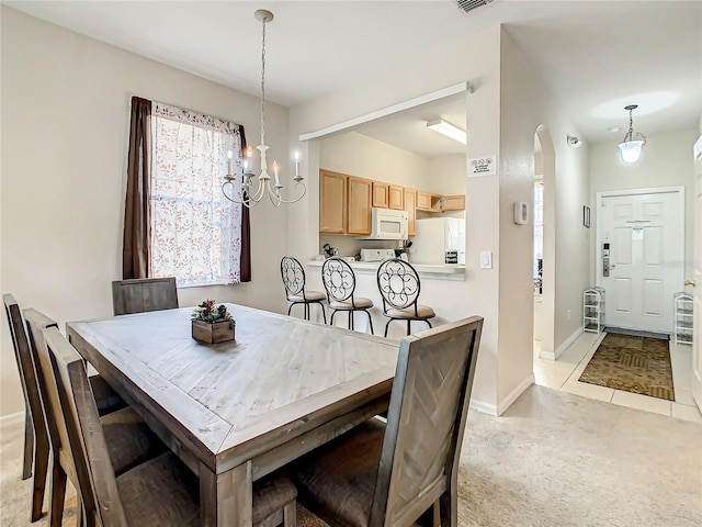 dining space with light colored carpet, a healthy amount of sunlight, and a chandelier