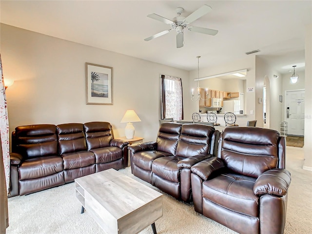 living room featuring light colored carpet and ceiling fan