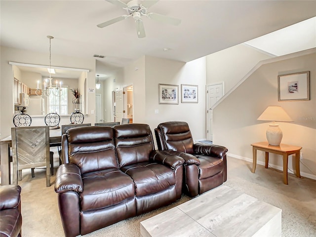 living room featuring light carpet and ceiling fan with notable chandelier