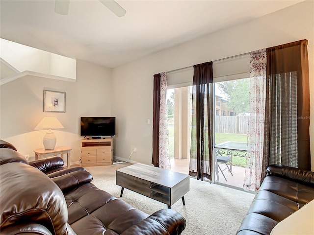 carpeted living room with ceiling fan