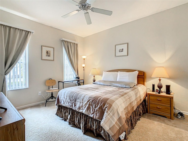 bedroom featuring light carpet and ceiling fan