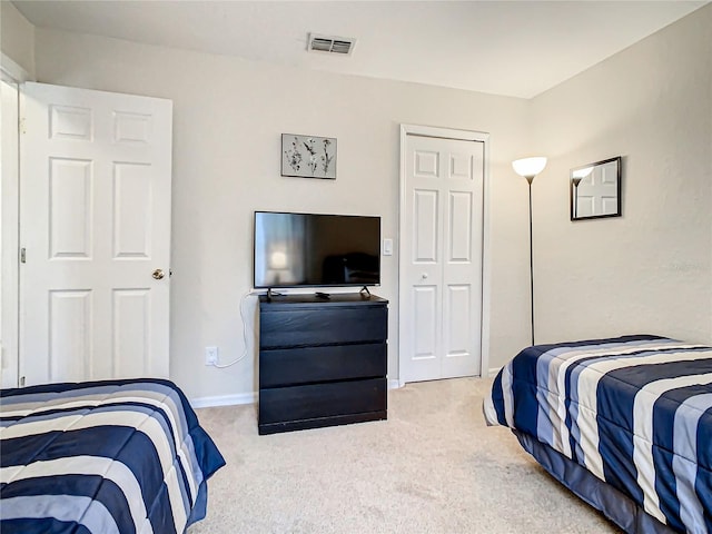 carpeted bedroom featuring a closet