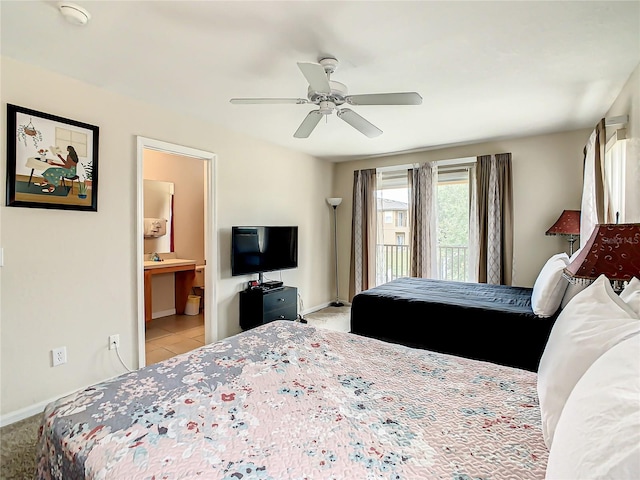 bedroom featuring ensuite bath, light tile flooring, and ceiling fan