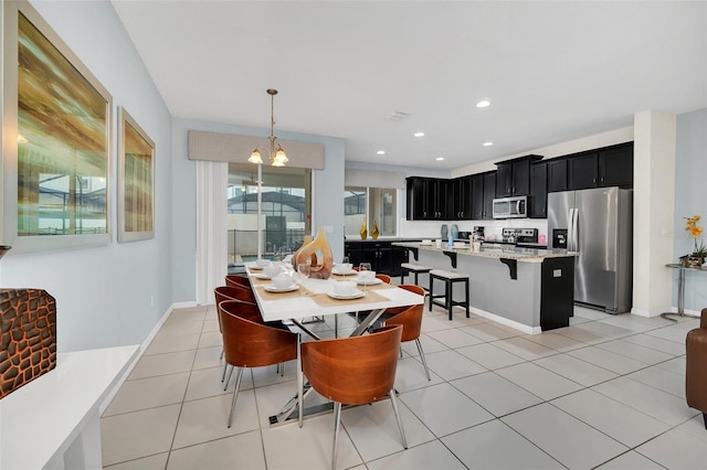 dining area with an inviting chandelier and light tile patterned floors