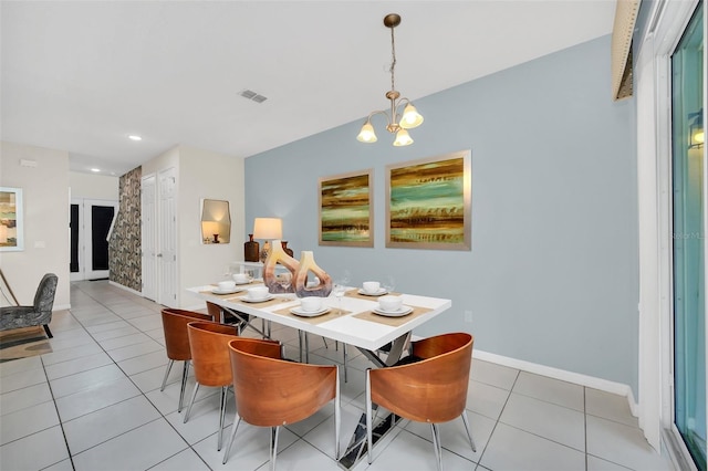 tiled dining room with a notable chandelier