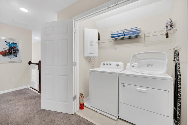 laundry room with light carpet, electric panel, and washing machine and clothes dryer