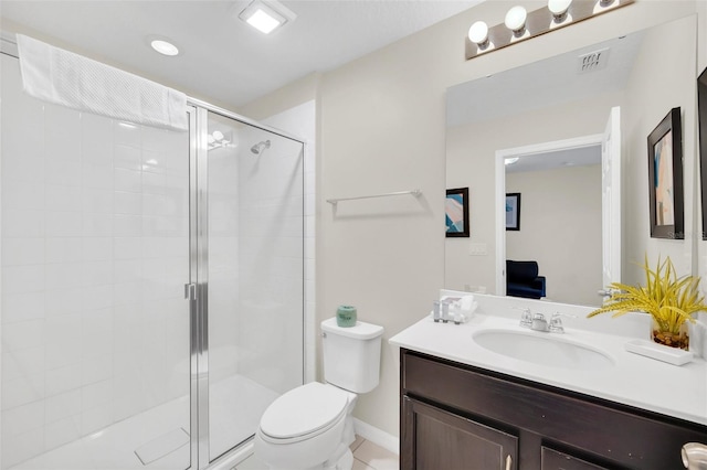 bathroom featuring vanity, toilet, and an enclosed shower