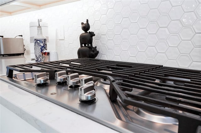 interior details with stove and tasteful backsplash