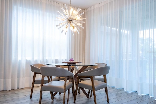 dining room with an inviting chandelier and light hardwood / wood-style flooring