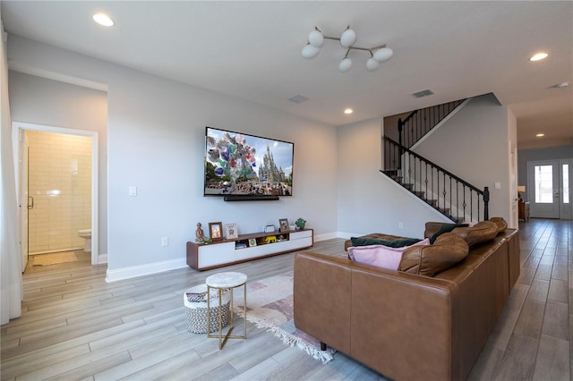 living room with french doors and light hardwood / wood-style floors