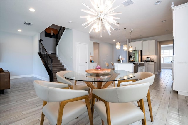 dining room featuring a chandelier and light hardwood / wood-style flooring