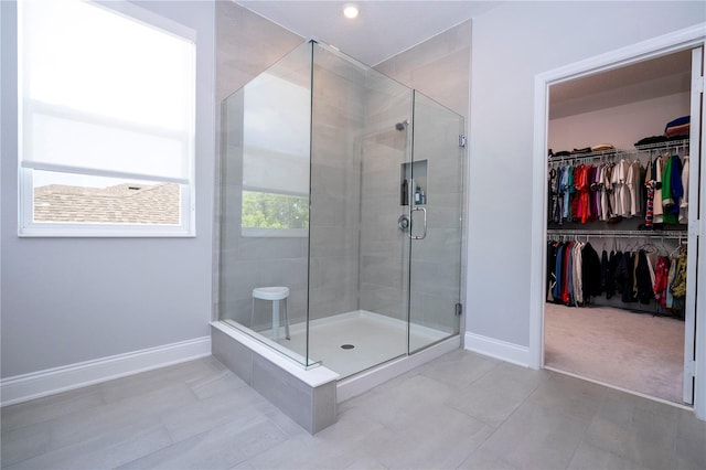 bathroom with tile floors and a shower with shower door