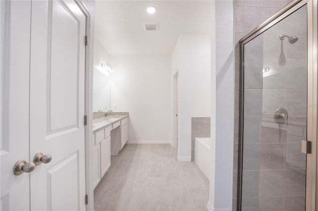 bathroom featuring vanity and independent shower and bath