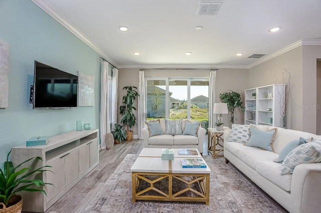 living room with ornamental molding and light wood-type flooring