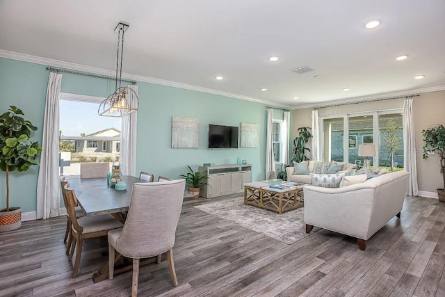 living room featuring wood-type flooring and crown molding