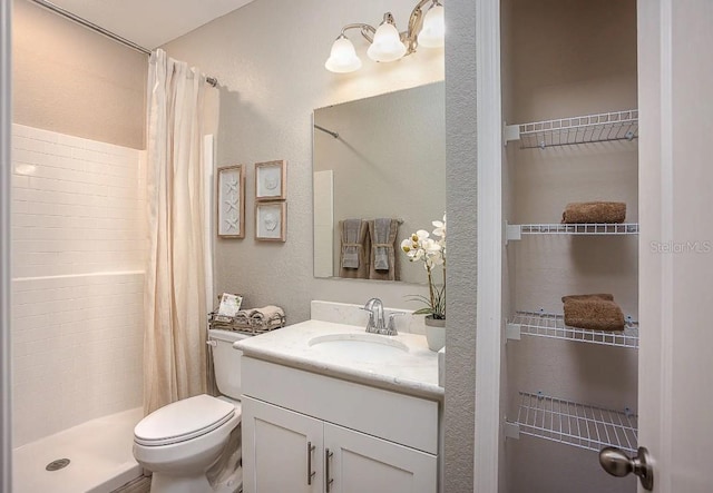 bathroom featuring vanity, toilet, and a shower with shower curtain