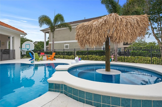 view of swimming pool with an in ground hot tub